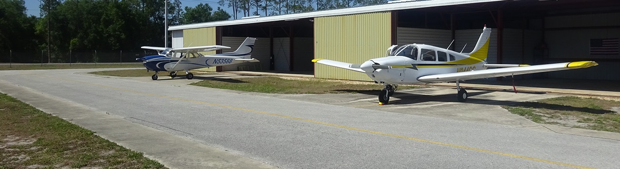 A plane parked on the side of a building
Description automatically generated